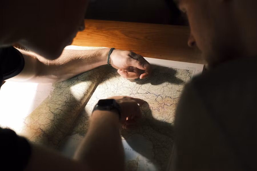 People studying a map together while planning a journey