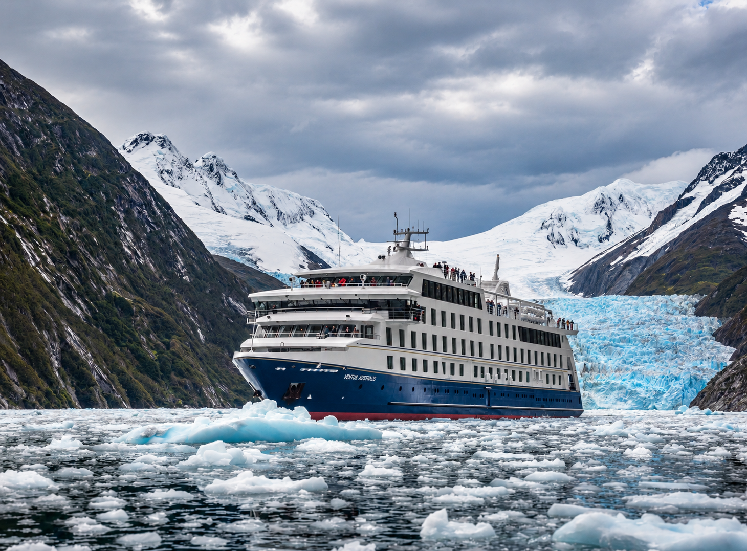 Australis expedition ship surrounded by floating ice beneath a Patagonian glacier