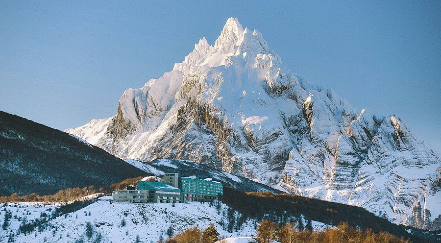 A mountainside hotel beneath snow-covered peaks near Ushuaia