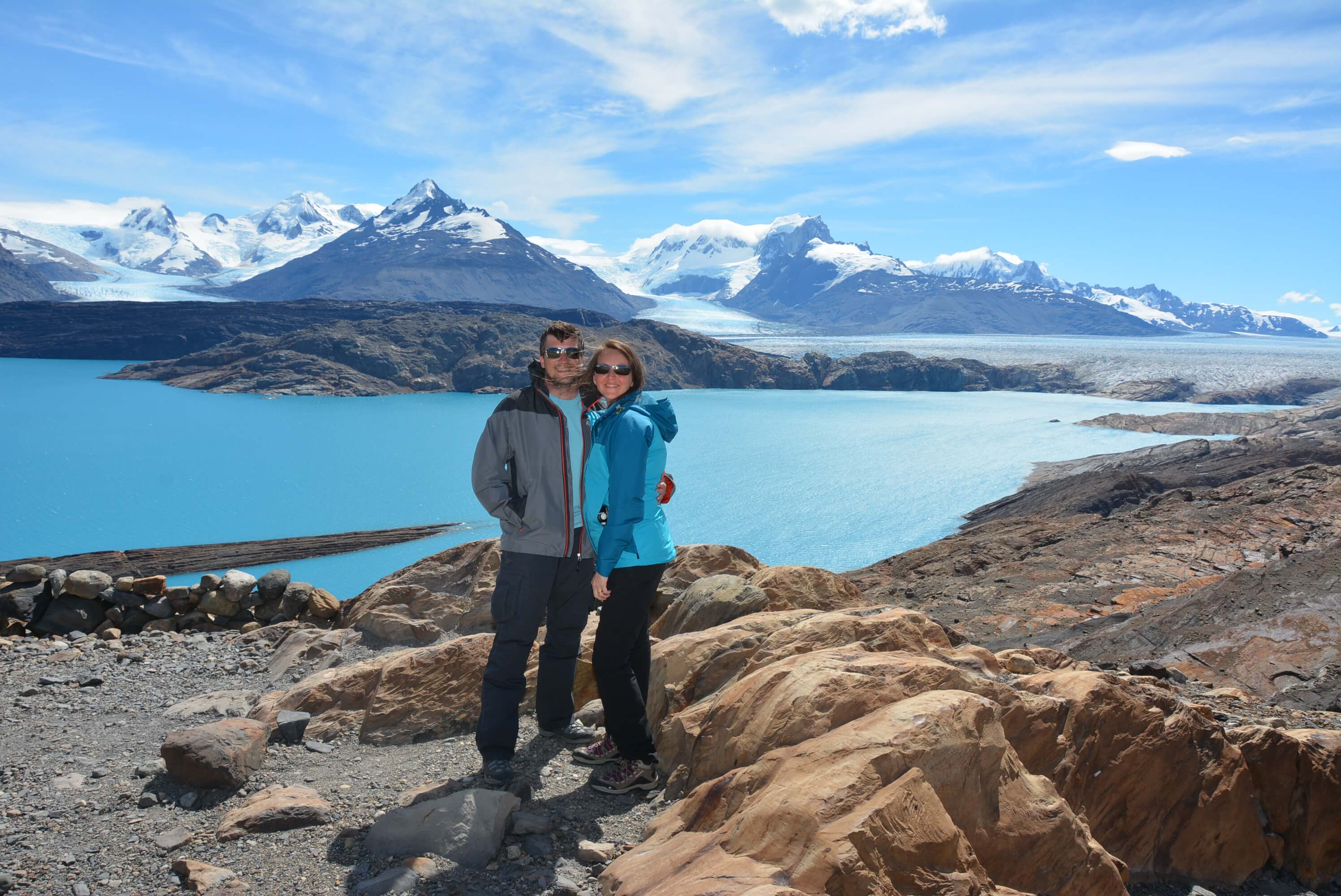 A couple enjoying a Patagonian landscape of turquoise water, glaciers and mountains